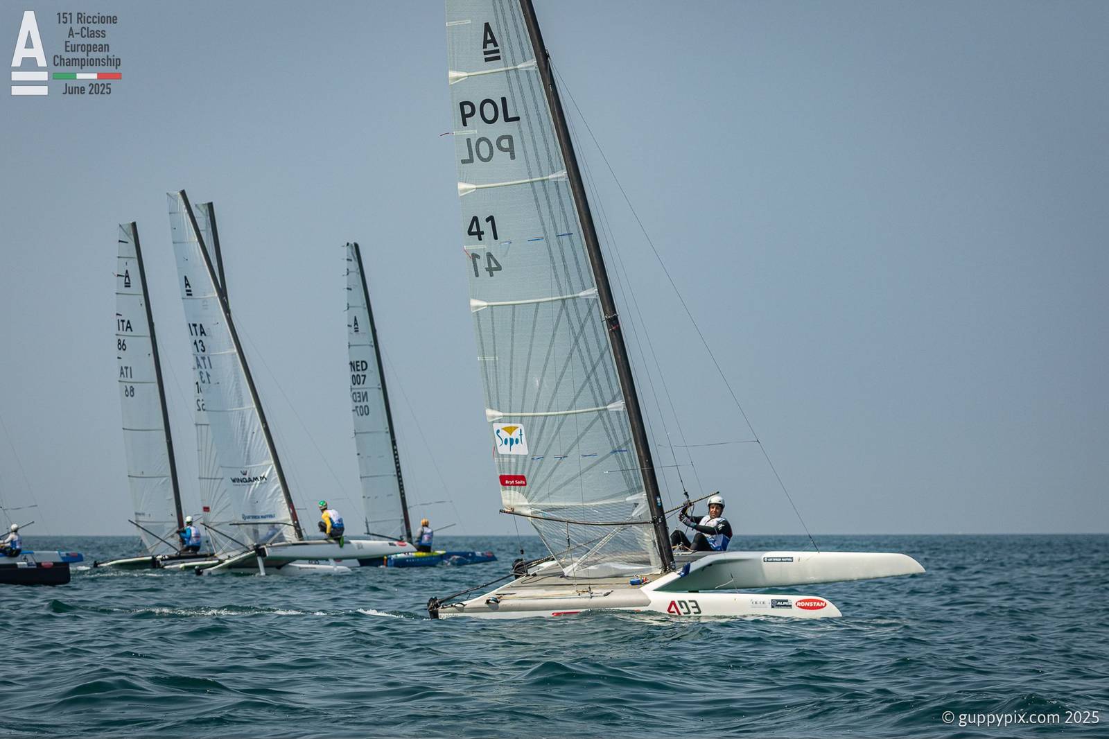 A-Cat Europeans 2025. Day 3 at Riccione. Kuba Suroviec leads the Open fleet. complete results at Catsailingnews web. Photo: @guppypix